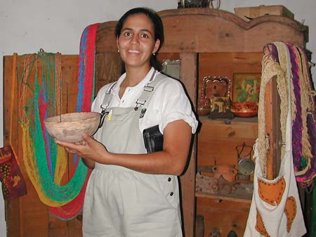 DSCN3086 Proprietor showing clay bowl made from the mud of the lake, 4x6 blowup