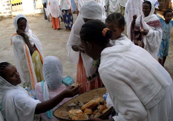 18 Handing out bread after the service