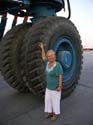 15  After the haul-out, Lois pats the huge tires of the rig.