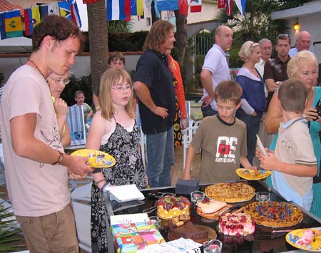 27 Josh and others gather around the cakes