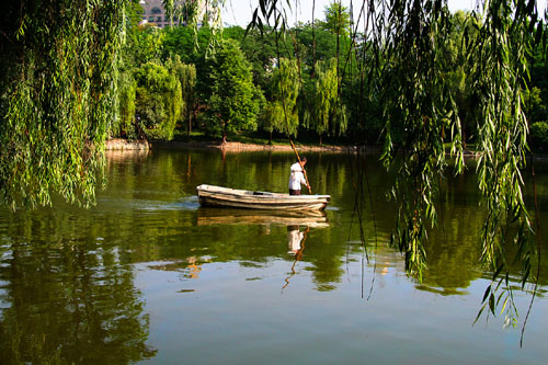 02 Lone Canoe Reflected on Lake in the City of Chengdu
