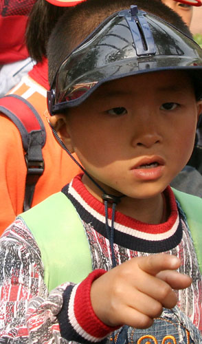 15 LIttle boy in huge visor pointing at a Panda