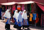 Muslim girls walking past stalls