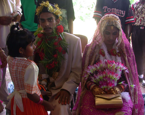 DSCN2056SisterComestoBrideandGroomastheySitSolumnlyontheirCh